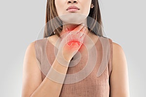 Sore throat woman on gray background