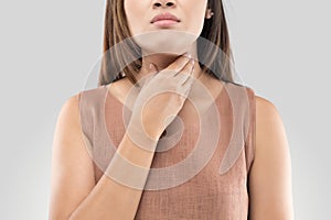 Sore throat woman on gray background photo