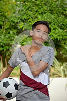 Sore Young Filipino Male Soccer Player With Soccer Ball