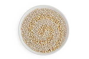 Sorghum seeds in ceramic bowl isolated on white background. Top view. Flat lay.