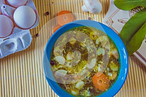 Sorrel green russian soup in the blue bowl