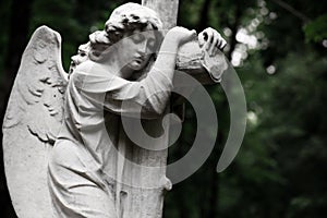 The Sorrowful Angel. Marble mourning angel with a cross, space f