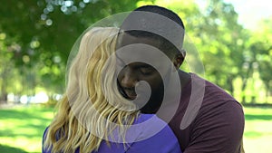 Sorrowful black man embraces beloved woman, clash of interests, misunderstanding