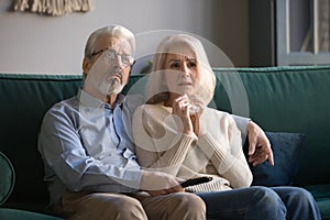Sorrowful elderly couple spend free time watching melodrama movie