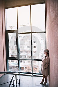 Sorrowful female standing in hall