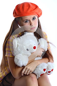 Sorrowful girl with white bear