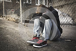 Sorrowful Kid on the City Street