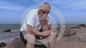 Sorrowful man near sea