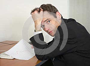 Sorrowful man at the office, on a workplace