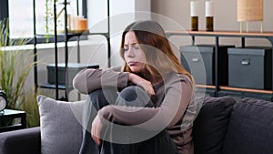 Sorrowful Woman In Stress Sitting Alone At Home