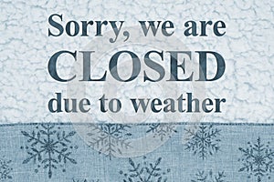 Closed due to weather sign on blue snowflake border on sherpa material