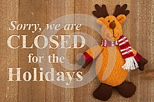 Sorry we are closed for the holidays sign with a winter moose