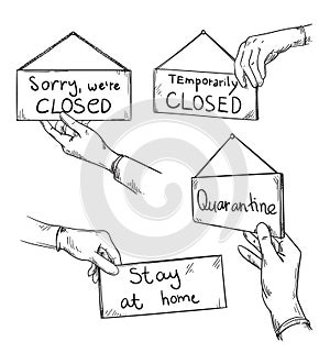 Sorry we are closed, quarantine warning  signs held by a hand in a protectie glove