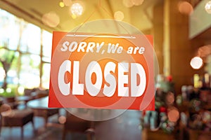 Sorry we are closed sign hang on door of business shop