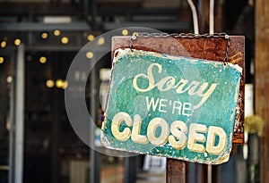 Sorry we are closed sign hanging outside a restaurant, store, of