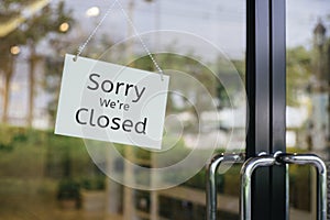 Sorry we are closed sign hanging outside a restaurant, store, office or other