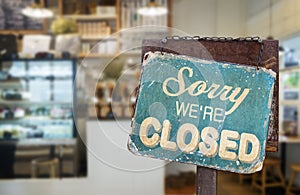 Sorry we are closed sign hanging outside a restaurant, store,