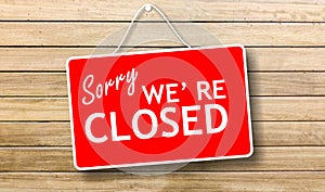 Sorry we are closed sign on wooden background