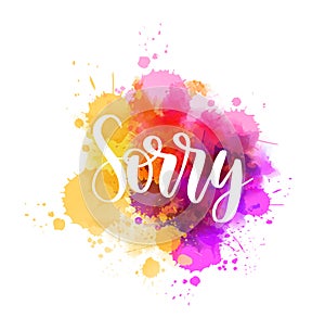 Sorry - handwritten modern calligraphy lettering on abstract watercolor paint splash background. Purple and pink colored. Apology
