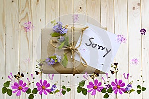 sorry message card handwriting with gift box, cosmos flowers