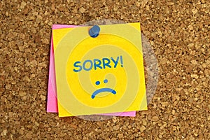sorry postit on corkboard