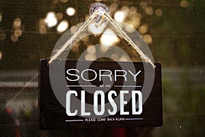 Sorry we`re closed - black and white wood sign on white wall