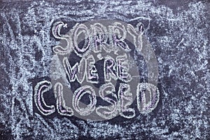 Sorry we`re closed. Chalk lettering on blackboard. Multi colored inscription