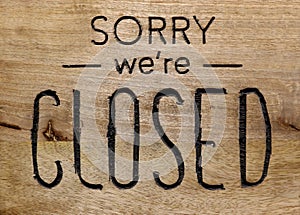 Sorry we`re closed, information sign on wooden signboard