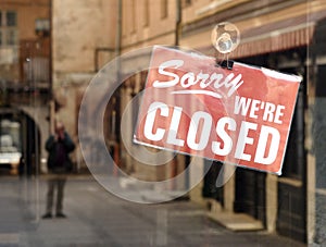 `Sorry we`re closed` sign on the cafe door.