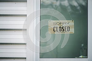 Sorry we`re closed sign. grunge image hanging on a door