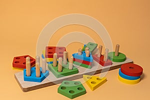 Sorter on neutral background. Multicolored logic sorter close up. Wooden educational logic toy for kid's. Montessori