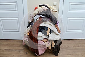 Sorting clothes after washing. Filling the basket with adult and baby cl