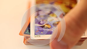 Sorting out tarot cards wheel of the year laid out on a white table, close-up