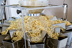 Sorting and packing line of snack onion ring at factory conveyor for cereal snack production of flour products, technology