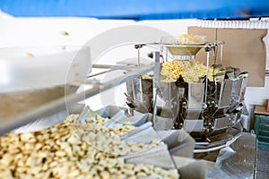 Sorting and packing line of snack onion ring at factory conveyor for cereal snack production of flour products, technology