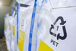 Sorting recyclables. The sorted polyethylene terephthalate PET plastic, is placed in a container with the appropriate marking photo