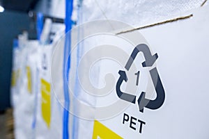 Sorting recyclables. The sorted polyethylene terephthalate PET plastic, is placed in a container with the appropriate marking photo