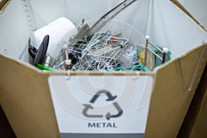 Sorting recyclables. The sorted scrap metal, is placed in a container with the appropriate marking