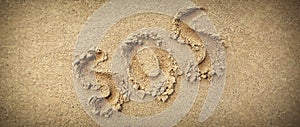 SOS abbreviation written on a wide sand background