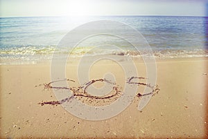 SOS inscription in the sand on the seashore