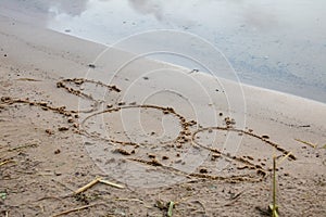 SOS letters in the sand on the beach