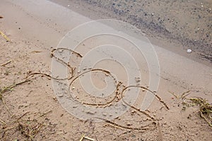 SOS letters in the sand on the beach
