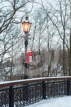 SOS police or emergency button in the public park under a luminous lantern