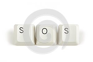 SOS from scattered keyboard keys on white