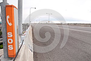 SOS sign and phone box on highway