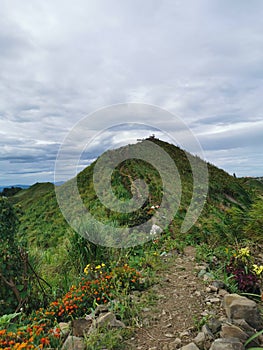 Sosodikon Hill green landscape at with a young man during cloudy day