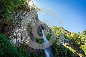 Sotillo waterfall in Sanabria with starry sun