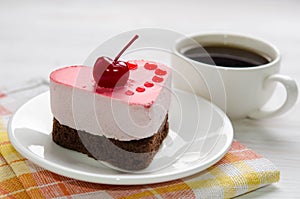 Souffle cake in the form of heart with cup of coffe
