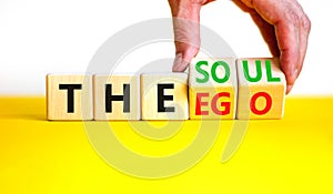 Soul or ego symbol. Concept word The soul or The ego on beautiful wooden cubes. Beautiful yellow table white background.