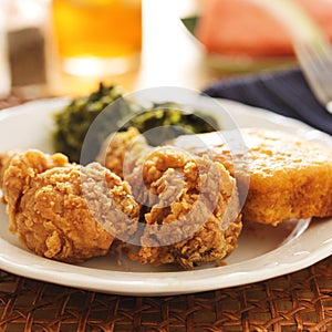 Soul food - fried chicken with collard greens and corn bread photo